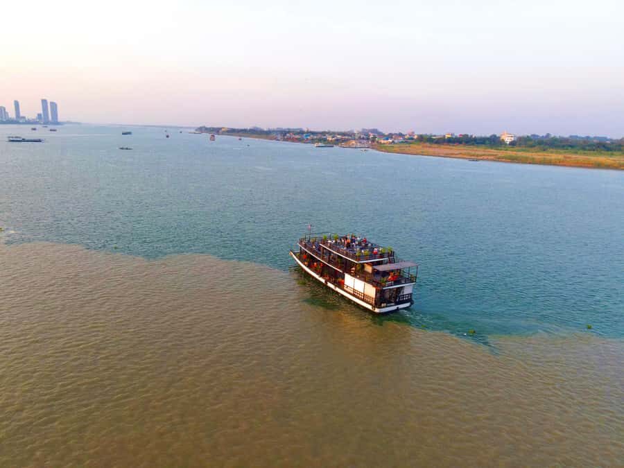 Phnom Penh: Sunset Cruise with Unlimited Beer &Fruit platter - Learning Riverbank Lifestyle: Stilted Houses, Fishing Boats, and Daily Work